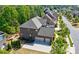 Aerial view of a stately brick home, featuring a two-car garage and a private fenced-in backyard at 16519 Flintrock Falls Ln, Charlotte, NC 28278