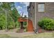 Backyard features a patio and wooden deck with stairway leading to the lush, green yard at 16519 Flintrock Falls Ln, Charlotte, NC 28278