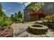 Brick home showcasing an outdoor fire pit, patio area, wooden deck, and landscaped yard at 16519 Flintrock Falls Ln, Charlotte, NC 28278