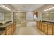A bathroom featuring dual vanities, tiled shower and large soaking tub at 16519 Flintrock Falls Ln, Charlotte, NC 28278