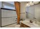 This bathroom has a walk-in shower, vanity with modern sink, and a decorative curtain at 16519 Flintrock Falls Ln, Charlotte, NC 28278