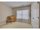 Bedroom with neutral walls, carpet, and a window with sheer, white curtains at 16519 Flintrock Falls Ln, Charlotte, NC 28278
