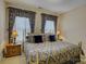Bedroom featuring a brass bed frame and decorative curtains at 16519 Flintrock Falls Ln, Charlotte, NC 28278