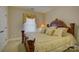Bedroom with decorative furnishings, large carved wooden headboard and accent pillows at 16519 Flintrock Falls Ln, Charlotte, NC 28278