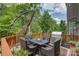 Exterior deck area with dining set, grill, green foliage, and wooded backyard at 16519 Flintrock Falls Ln, Charlotte, NC 28278