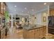 This well-lit dining area connects to the living room and features an island with granite countertop and stainless steel appliances at 16519 Flintrock Falls Ln, Charlotte, NC 28278