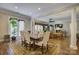 Spacious dining area with hardwood floors, elegant columns, and a view to living area at 16519 Flintrock Falls Ln, Charlotte, NC 28278