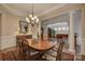 Elegant dining room with hardwood floors, decorative pillars, and a stylish chandelier at 16519 Flintrock Falls Ln, Charlotte, NC 28278