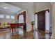 Elegant foyer with hardwood floors, piano, a decorative plant stand, and an inviting ambiance at 16519 Flintrock Falls Ln, Charlotte, NC 28278