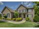 Charming two-story brick home with a beautifully landscaped front yard and a welcoming entrance at 16519 Flintrock Falls Ln, Charlotte, NC 28278