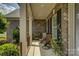 Charming front porch with comfortable seating, potted plants, and decorative brick accents at 16519 Flintrock Falls Ln, Charlotte, NC 28278