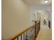 A hallway featuring a wood and wrought iron banister at 16519 Flintrock Falls Ln, Charlotte, NC 28278