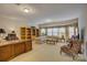 A large living room featuring a custom built-in bookcase and a seating area by a large window at 16519 Flintrock Falls Ln, Charlotte, NC 28278
