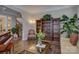 Stylish living room with hardwood floors, elegant furniture, bookshelves, and decorative accents at 16519 Flintrock Falls Ln, Charlotte, NC 28278