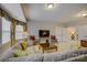 A spacious living room featuring a large sectional sofa, window seat, and television at 16519 Flintrock Falls Ln, Charlotte, NC 28278