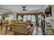 This living room offers hardwood floors, decorative window treatments, ample seating, and natural light at 16519 Flintrock Falls Ln, Charlotte, NC 28278