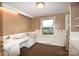Bathroom featuring double sinks, vintage finishes, and natural light at 17389 Mooresville Rd, Mooresville, NC 28115