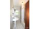 Charming bathroom featuring a pedestal sink, tiled floor, and a classic bathtub at 17389 Mooresville Rd, Mooresville, NC 28115