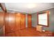 A bedroom featuring hardwood floors, soft gray walls, wood trim, and closet offering comfortable living at 17389 Mooresville Rd, Mooresville, NC 28115