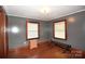 Bedroom featuring hardwood floors, gray walls and windows offering light and a comfortable living space at 17389 Mooresville Rd, Mooresville, NC 28115