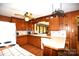 Nostalgic kitchen with retro wood cabinets and a practical layout at 17389 Mooresville Rd, Mooresville, NC 28115