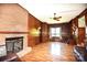 Inviting living room showcasing brick fireplace and ample natural light at 17389 Mooresville Rd, Mooresville, NC 28115