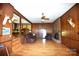 Cozy living room with hardwood floors, fireplace and wood-paneled walls at 17389 Mooresville Rd, Mooresville, NC 28115