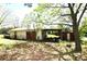 Exterior view of shed with an open car port and foliage at 17389 Mooresville Rd, Mooresville, NC 28115