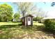 A small red outbuilding stands in the sun on a lawn at 17389 Mooresville Rd, Mooresville, NC 28115