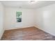 Inviting bedroom with wood-look flooring and ample natural light at 1938 Dembrigh Ln, Charlotte, NC 28262
