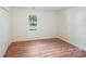Neutral bedroom with wood-look floors and ample natural light at 1938 Dembrigh Ln, Charlotte, NC 28262