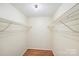 Walk-in closet with wire rack shelving and hardwood floors at 1938 Dembrigh Ln, Charlotte, NC 28262