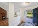 Bright entryway leading to an open-concept living area featuring a brick fireplace at 1938 Dembrigh Ln, Charlotte, NC 28262