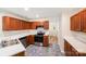 Kitchen with stainless steel appliances, wood cabinets, and stone tile floors at 1938 Dembrigh Ln, Charlotte, NC 28262