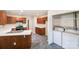 Well-equipped kitchen features wood cabinets, stainless steel appliances, and a laundry area at 1938 Dembrigh Ln, Charlotte, NC 28262