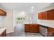 Open kitchen featuring a peninsula with seating, wood cabinets, and views to the backyard at 1938 Dembrigh Ln, Charlotte, NC 28262
