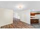 Spacious living room boasts wood floors, white walls, and a view of the kitchen at 1938 Dembrigh Ln, Charlotte, NC 28262