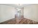 Bright living room featuring wood floors, white walls, and a view into the next room at 1938 Dembrigh Ln, Charlotte, NC 28262