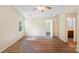 Bedroom includes wood floors, a ceiling fan, and an attached bathroom at 1938 Dembrigh Ln, Charlotte, NC 28262