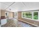 Bright sunroom with tile flooring, natural light, and access to the backyard at 1938 Dembrigh Ln, Charlotte, NC 28262