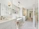 Bright bathroom featuring double vanity, tub, walk-in shower, and elegant white cabinetry at 2018 Radcliffe Ave, Charlotte, NC 28207