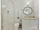Clean bathroom featuring a glass-enclosed shower, classic vanity, and a neutral color palette at 2018 Radcliffe Ave, Charlotte, NC 28207