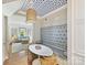 Cozy breakfast nook with a built-in banquette, unique ceiling decor, and an inviting view into the living area at 2018 Radcliffe Ave, Charlotte, NC 28207
