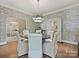 Elegant dining room with patterned wallpaper, hardwood floors, and modern lighting at 2018 Radcliffe Ave, Charlotte, NC 28207