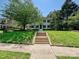 Two-story brick home with well-manicured front yard and mature trees at 2018 Radcliffe Ave, Charlotte, NC 28207