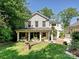 Charming house showcasing its front porch and manicured lawn surrounded by mature trees at 2018 Radcliffe Ave, Charlotte, NC 28207
