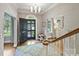 Elegant foyer with wood flooring, neutral walls, black front door, and stylish light fixtures at 2018 Radcliffe Ave, Charlotte, NC 28207