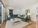 Comfortable living room featuring a plush green sofa, large window, and decorative accents at 2018 Radcliffe Ave, Charlotte, NC 28207