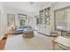 Bright living room featuring stylish decor, large windows, and a custom built-in shelving unit at 2018 Radcliffe Ave, Charlotte, NC 28207