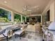 Relaxing covered patio with stone fireplace, ceiling fans, outdoor seating, and a built-in grill at 2018 Radcliffe Ave, Charlotte, NC 28207